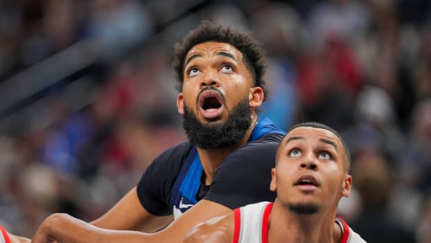 Mar 4, 2024; Minneapolis, Minnesota, USA; Minnesota Timberwolves center Karl-Anthony Towns (32) rebounds against the Portland Trail Blazers forward Kris Murray (8) in the third quarter at Target Center.